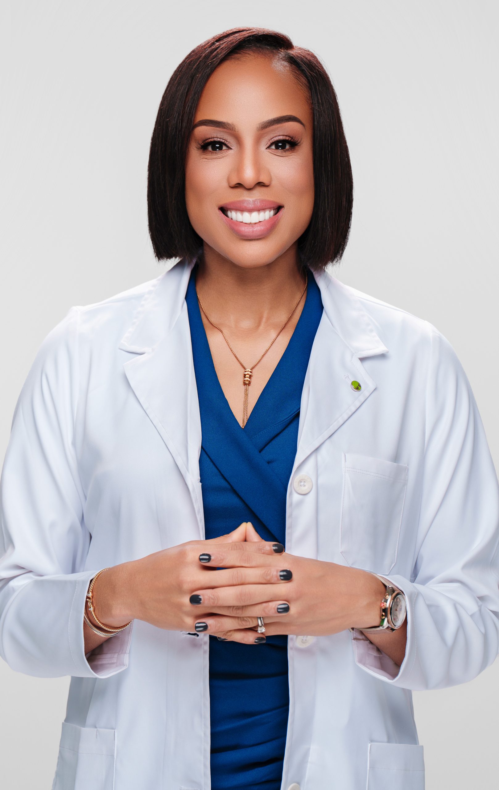 Dr. Kelechi Okafor smiling in white coat
